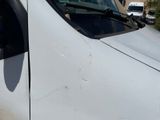 a white van that is parked on the side of the road