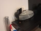 a bowl of food on a table in front of a television