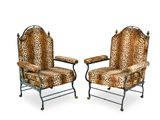 pair of leopard print chairs with metal legs and arms