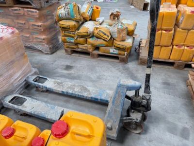 une palette sur laquelle sont posés plusieurs conteneurs jaunes, dans un entrepôt