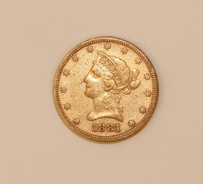 a gold coin with a woman ' s head on it