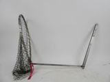 a net and a pair of skis sitting on the ground