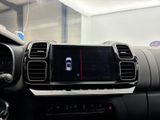 the dashboard of a car with a display of a cell phone in the center of it