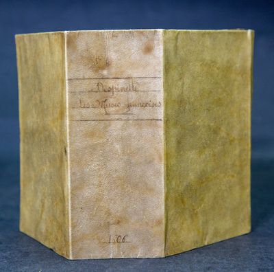 an old book sitting on top of a table next to a black background