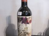 une bouteille de vin posée sur une table à côté d'une bouteille de vin