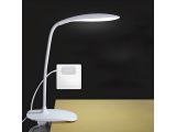 a white lamp sitting on top of a table next to a wall