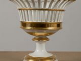 gold and white glass vase on a gold base