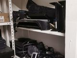 a lot of electronic equipment on the shelves in the room