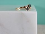 an image of a black diamond ring sitting on top of a white marble block