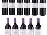 many bottles of wine that are lined up on the table