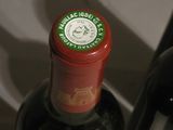 two bottles of wine sitting next to each other on a table