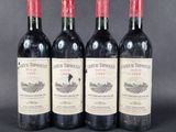 three bottles of red wine sitting on top of a table