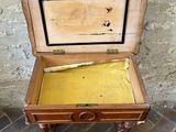 a small wooden box with a baseball bat inside of it