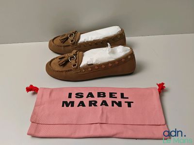 a pair of shoes and a pink bag on a table