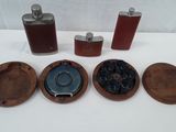 four flasks, a bottle, and a tray on a table