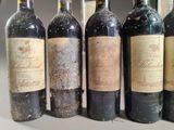 several bottles of wine are lined up in a row