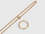 a gold ring and chain on a white background