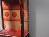 a small display case with a red and gold design on it