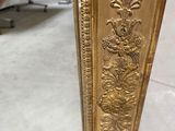 an image of a gold mirror with a decorative design on it
