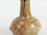 a small brown vase sitting on a white surface