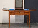 a small wooden table with a mirror on top of it