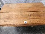 an old wooden table with a sticker on the top of it
