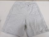 grey nike shorts on a white table with a bottle of water