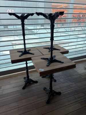 two wooden tables sitting on top of a wooden floor