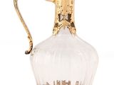 an image of a gold and clear glass pitcher on a white background