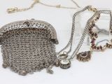a silver purse with a chain around it on a table