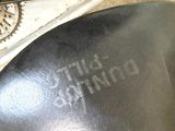 a close up of a motorcycle seat with a clock on the back of it