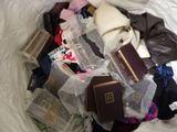 a pile of clothing that is sitting on a bed