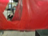 a red tarp covering a car in a garage