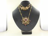 necklace and earring set on a mannequin display stand