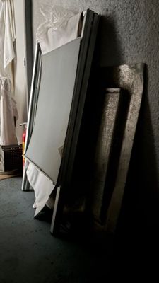 a refrigerator sitting in the corner of a room next to a window