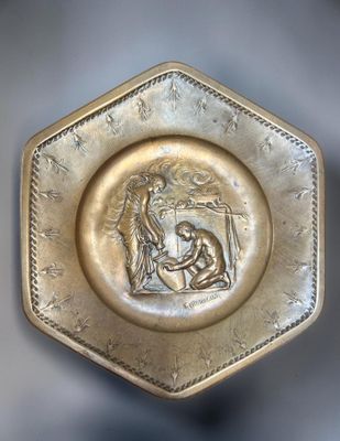 a gold plate with a picture of a woman and a man
