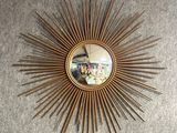 a picture of a sunburst hanging on the wall