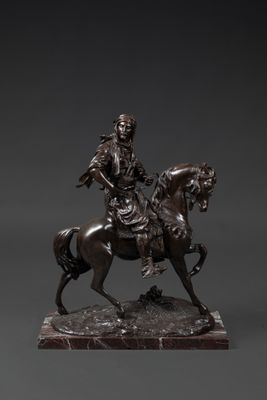 a bronze statue of a man riding a horse on a marble base