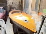 a boat and a car in a garage next to each other