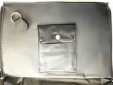 a black purse with a metal ring on it