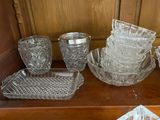 many pieces of glass sitting on a wooden shelf