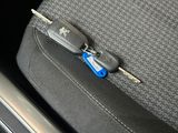 a car seat with a pair of glasses and a pair of keys on it