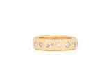 a close up of a gold ring with diamonds on it