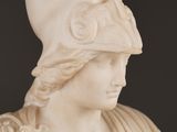 marble bust of a woman wearing a helmet with a feather on her head