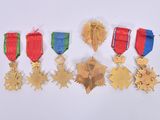 five medals and a star on a white surface