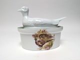 a white bird sitting on top of a white container