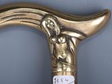 a gold colored cane with a picture of a woman on it