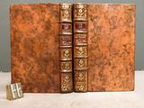 two old books that are sitting on a table