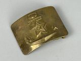 an old brass belt buckle with a star and anchor on it