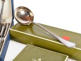 a box of silverware with a spoon and spoon rest in it